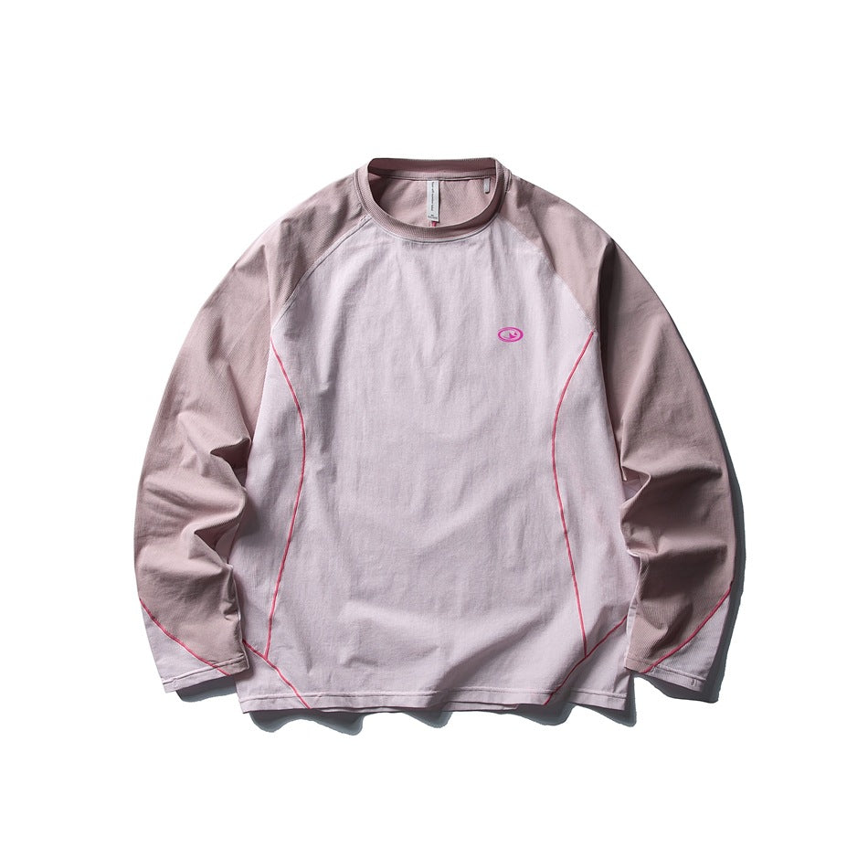 Pink long-sleeve raglan top with dusty mauve sleeves and collar, hot pink piping and small chest logo, flat lay
