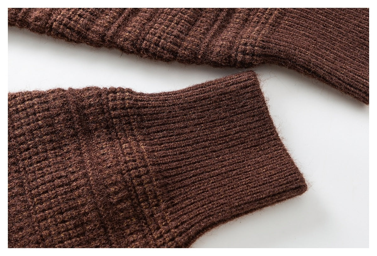 Close-up of a brown knit sleeve cuff with ribbing and textured stitching.