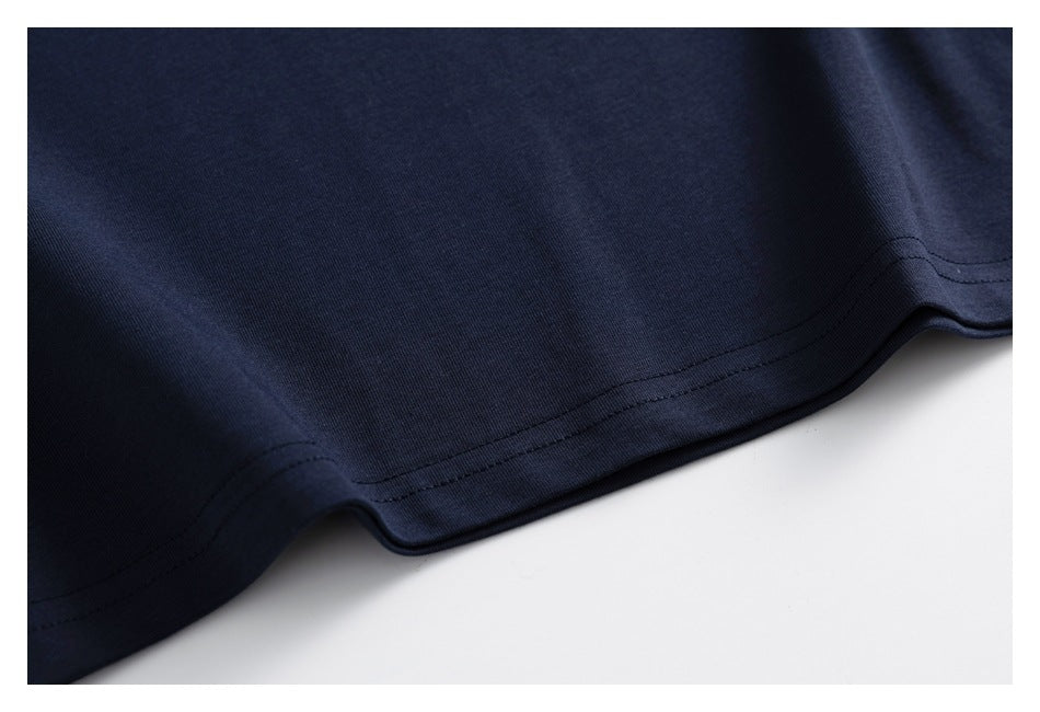 Close-up of the double-stitched hem on dark navy fabric.