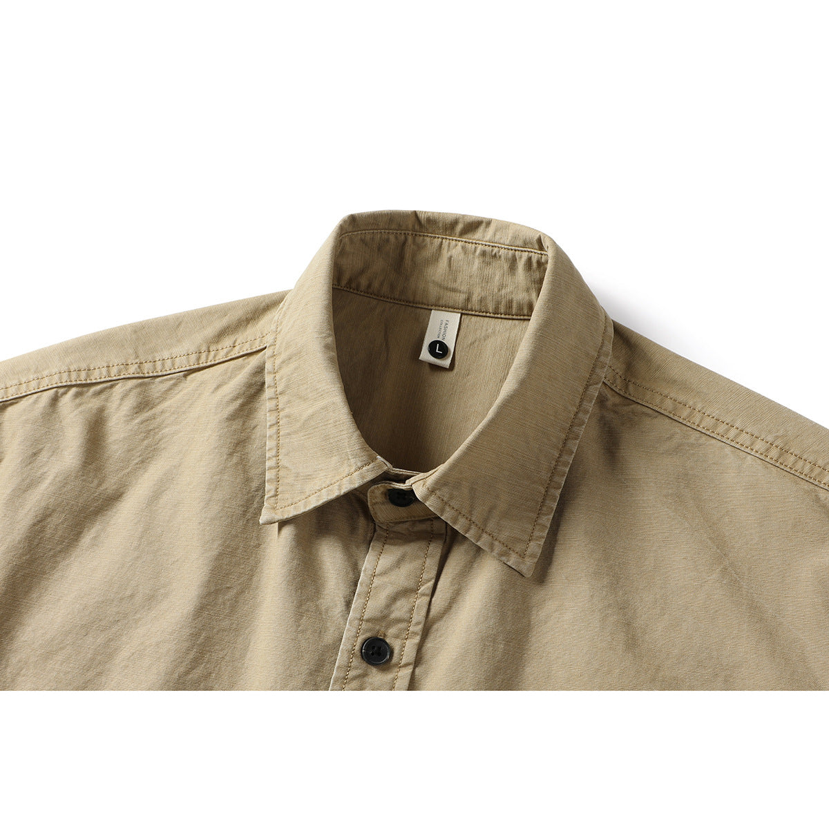Close-up of a tan button-up shirt showing its pointed collar, front placket, black buttons, and inner size tag.