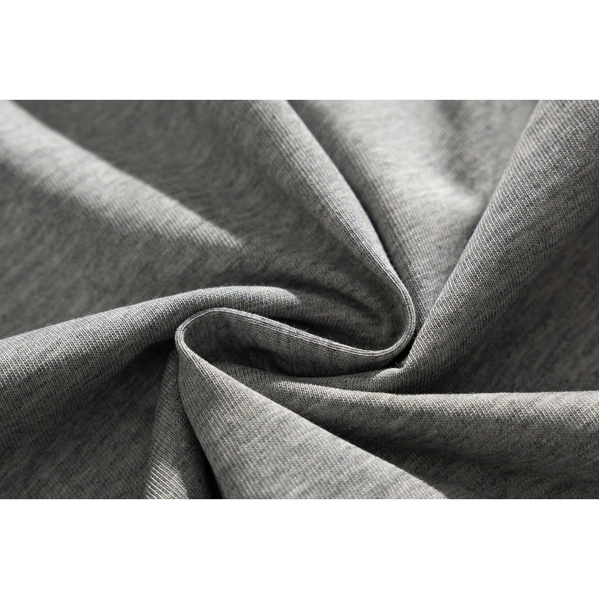 Close-up of gray fabric draped to show its knit texture and soft folds.
