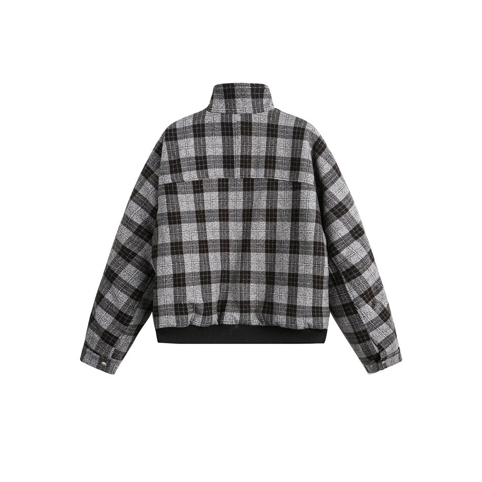 Back view of a black, gray, and white plaid jacket with a high collar, long sleeves, and black ribbed hem.