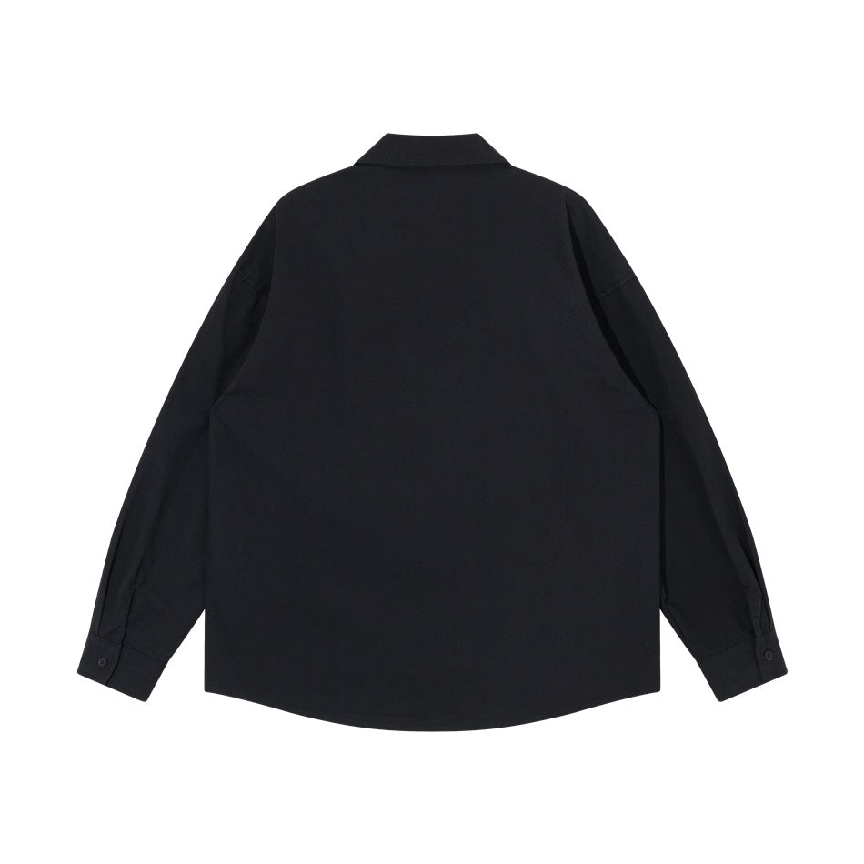Back view of black long-sleeve shirt with pointed collar, dropped shoulders, button cuffs and curved hem, flat lay