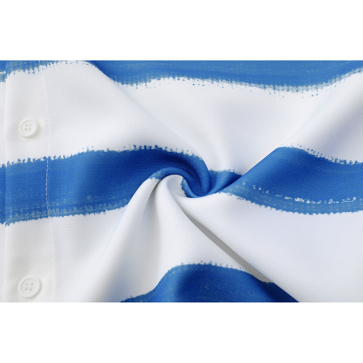 Close-up of white fabric with broad blue brushstroke stripes and two white buttons, gathered into a twist.