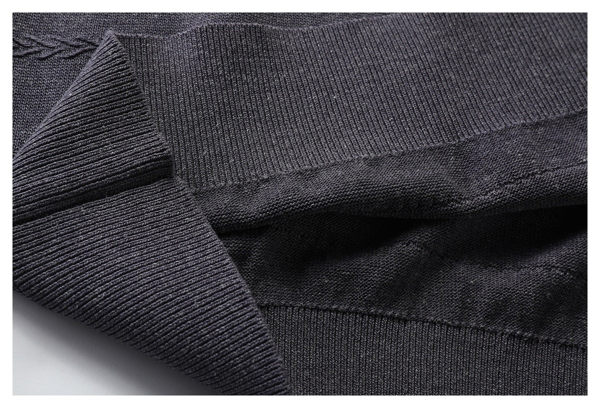 Close-up of a wide ribbed band folded over charcoal knit fabric.