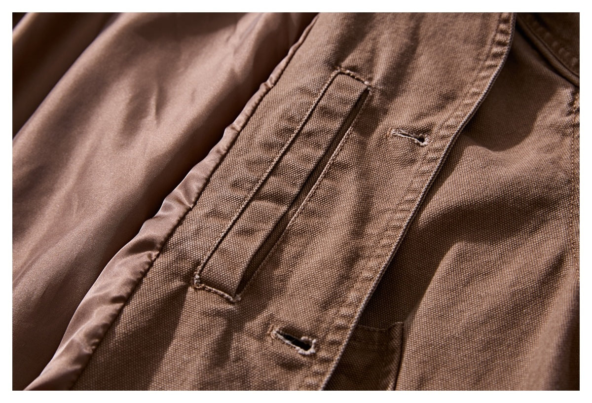 Close-up of the open brown jacket showing its smooth inner lining, placket, and buttonholes.