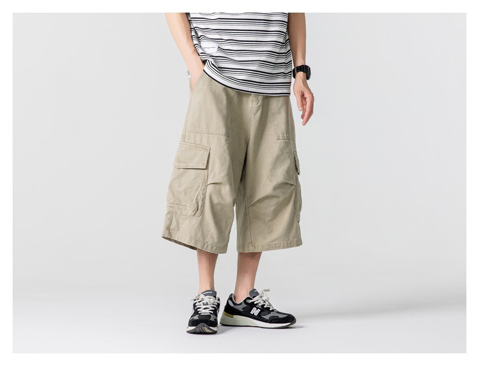 Front view of a model wearing light khaki knee-length cargo shorts with flap pockets.