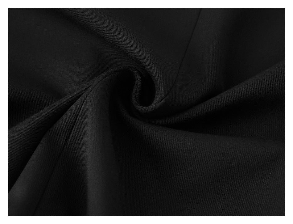 Close-up of black fabric gathered into a soft spiral fold.