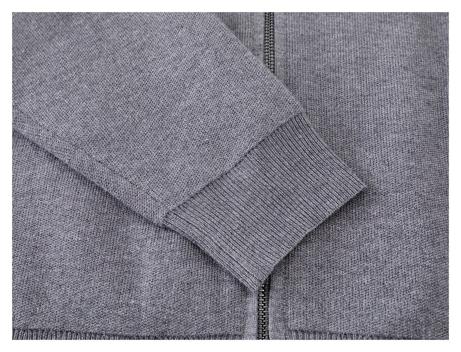 Close-up of the gray knit sleeve cuff, with the front zipper visible beside it.
