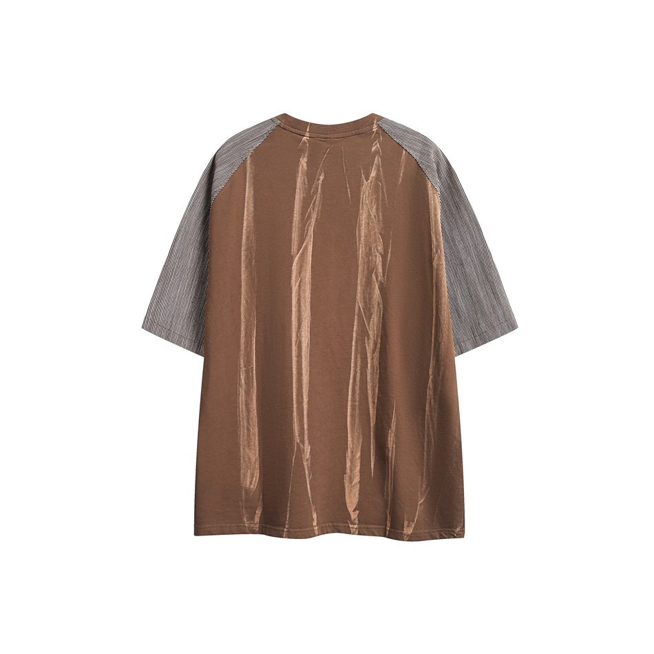 Back view of a brown oversized T-shirt with striped raglan sleeves and pale vertical streaks.
