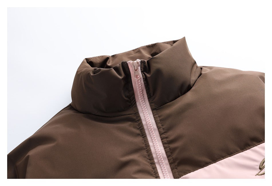 Close-up of the brown jacket's high collar and pale pink front zipper.