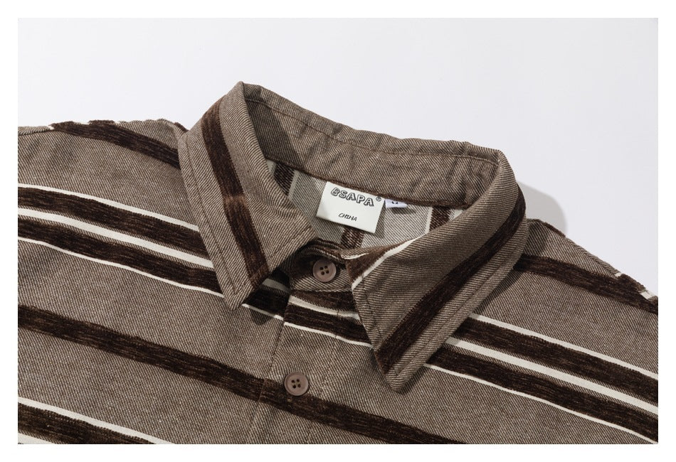 Close-up of a brown striped shirt collar and upper front, including buttons and the sewn neck label.