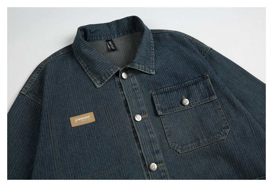 Close-up of the jacket's front collar, silver buttons, chest pocket, and small rectangular chest patch.