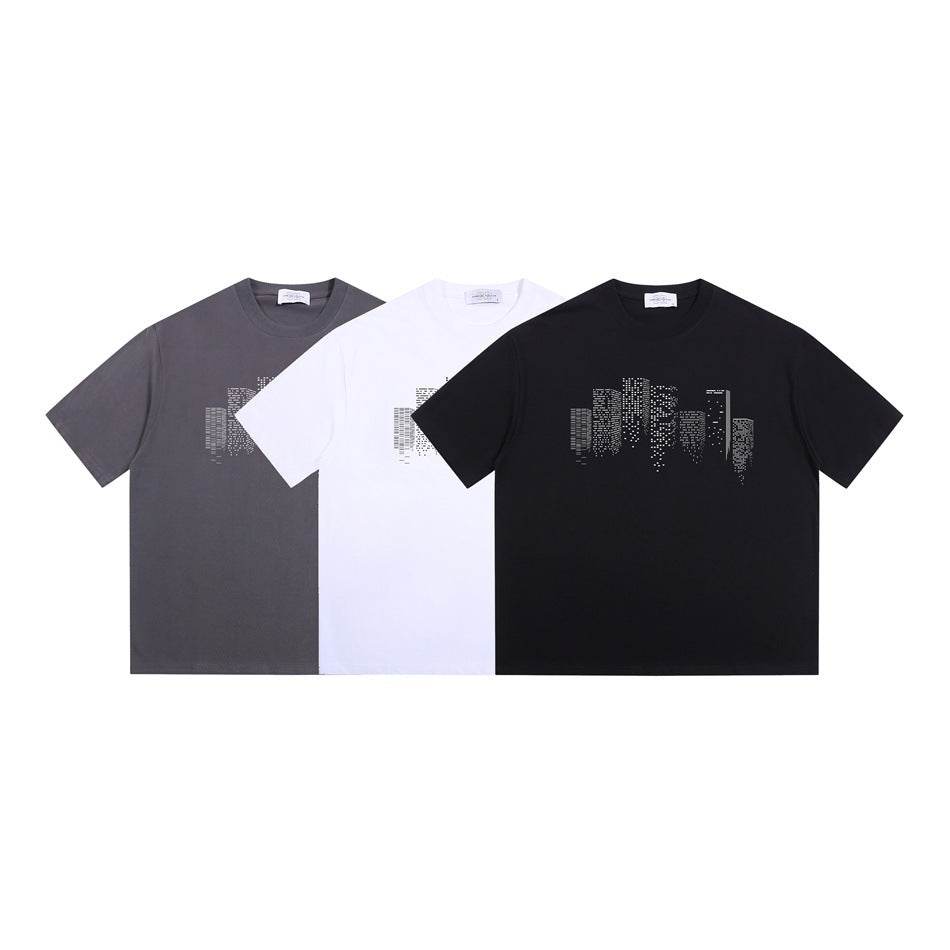 Three short-sleeve crew-neck T-shirts in charcoal gray, white, and black, each with a geometric chest print.
