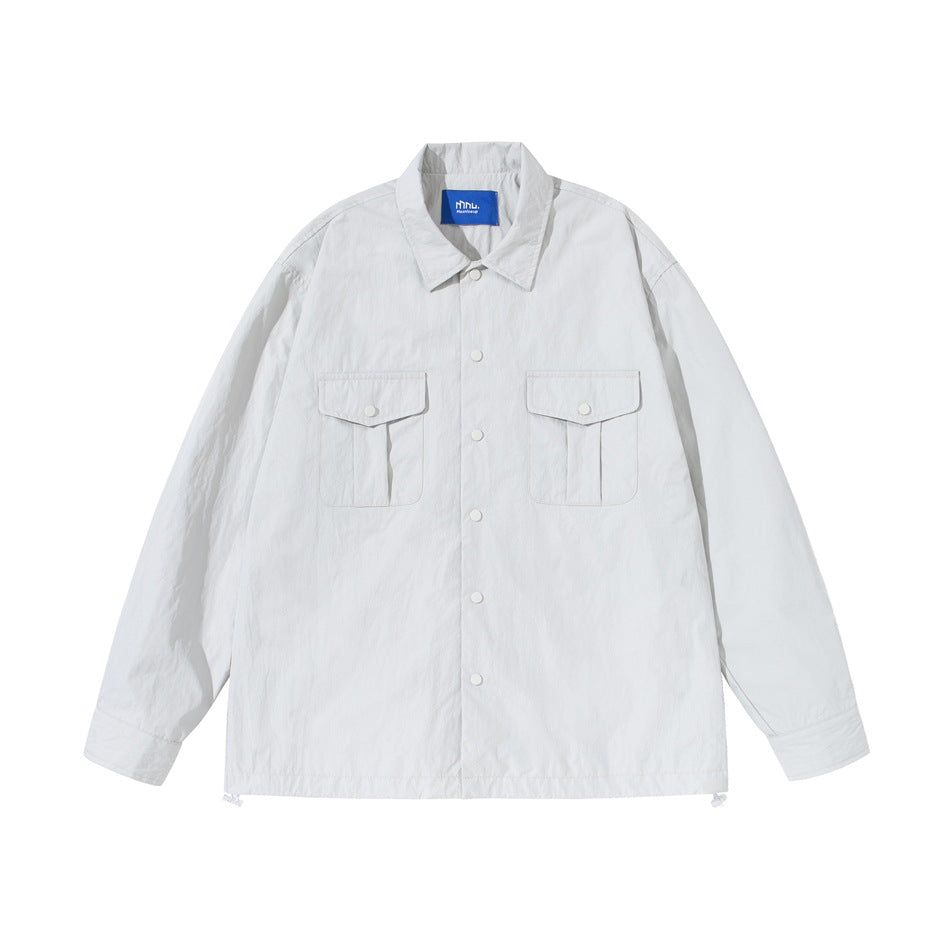 Off-white shirt-style jacket flat lay, front view with snap buttons, two flap chest pockets and drawstring hem