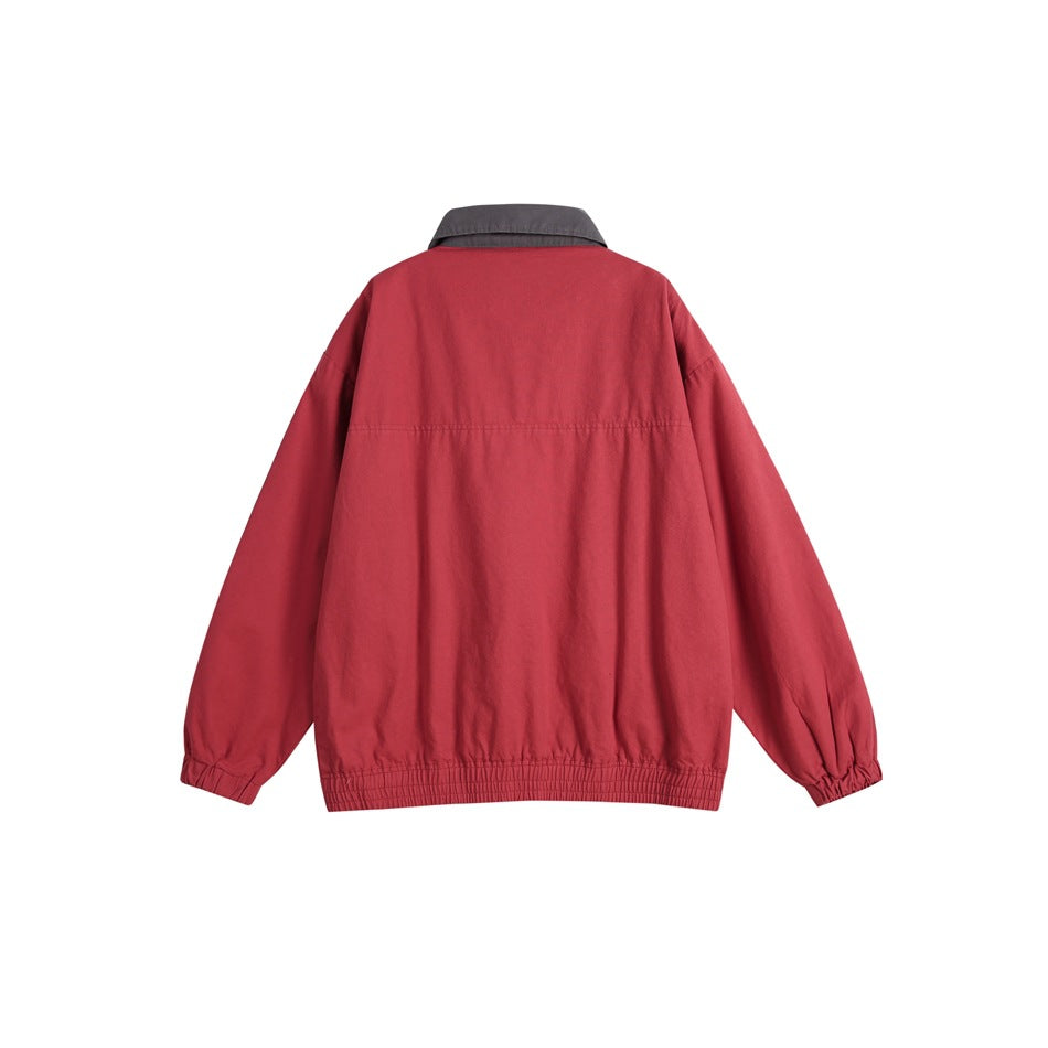 Back view of a muted red jacket with a charcoal collar, long sleeves, and elastic cuffs and hem.