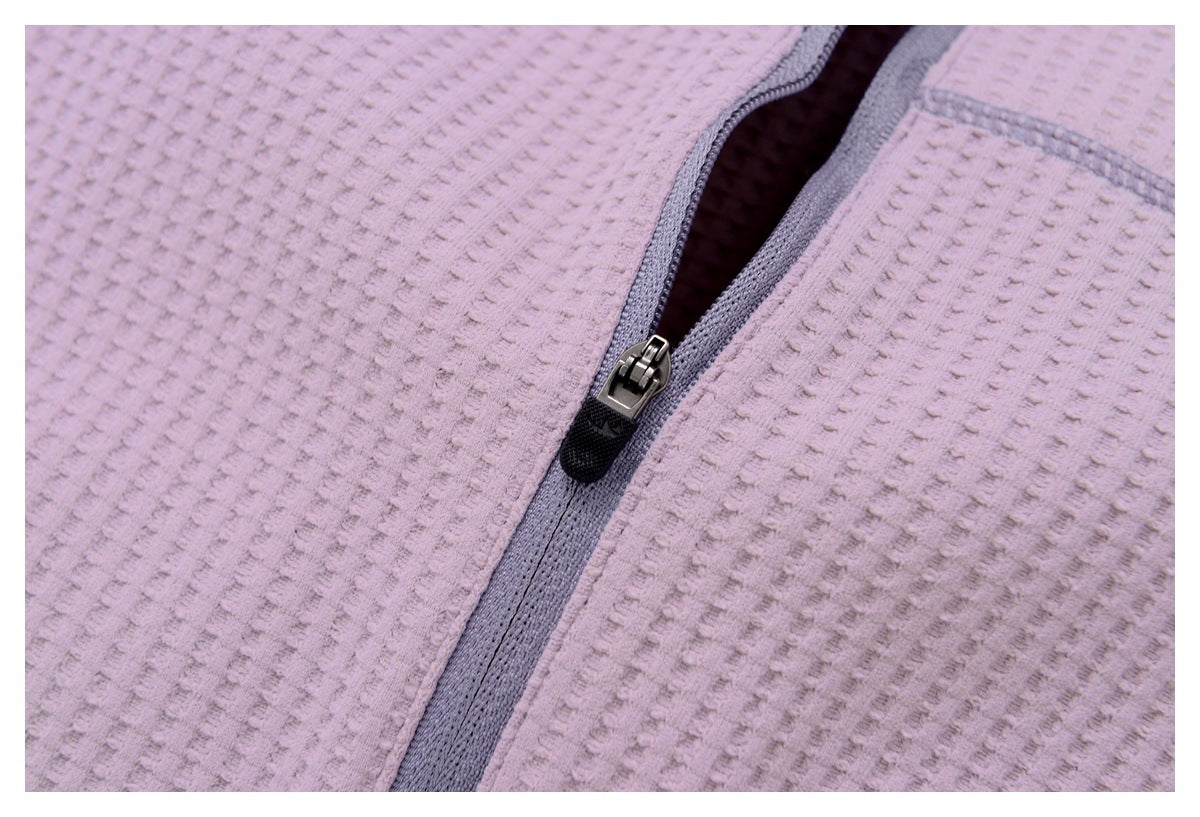 Close-up of the gray zipper and textured mauve fabric on a jacket.