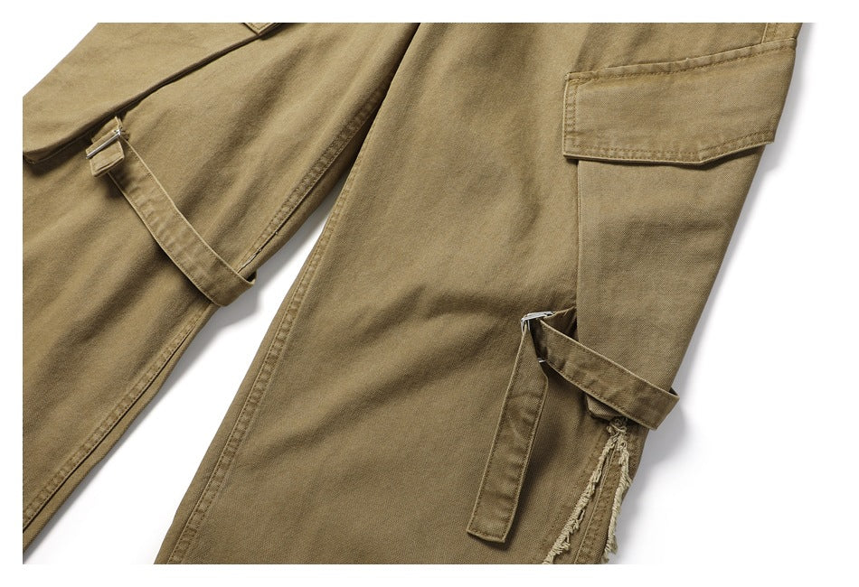 Detail of khaki cargo trouser legs showing flap pockets and adjustable side straps.