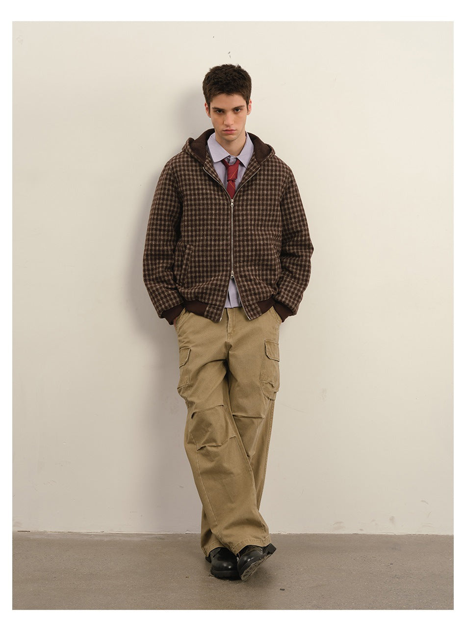 Model wearing a brown checked zip jacket with a hood and khaki cargo pants.