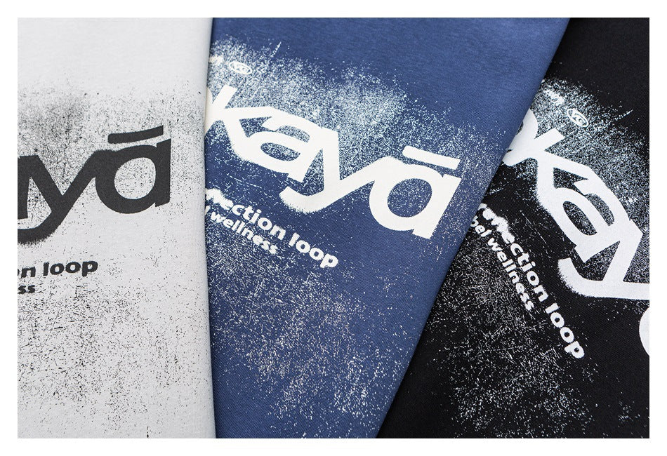 Close-up of white, blue, and black sweatshirt colorways with distressed white graphic lettering.