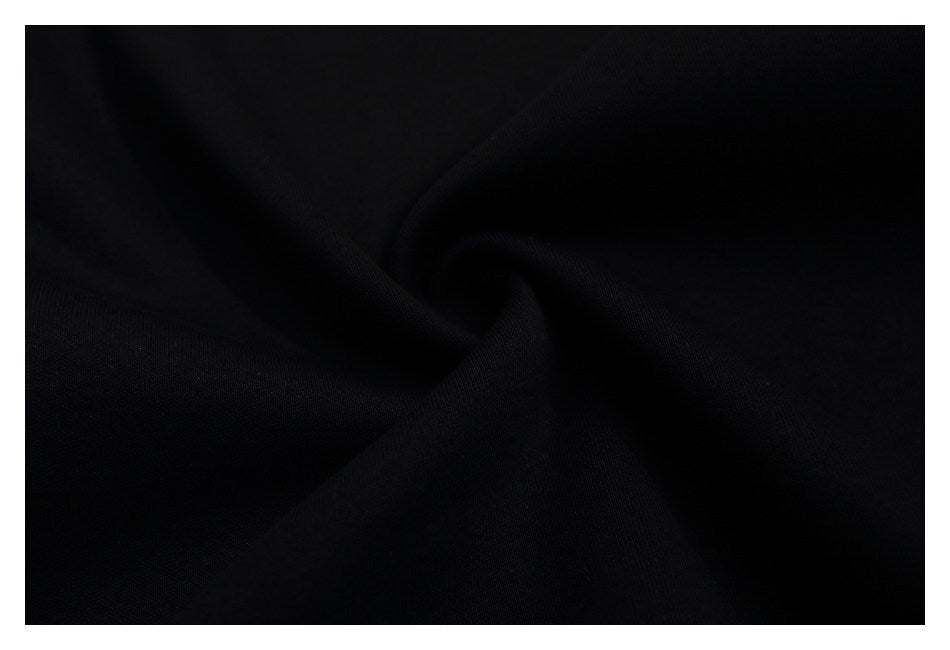 Close-up of black fabric gathered into soft folds.