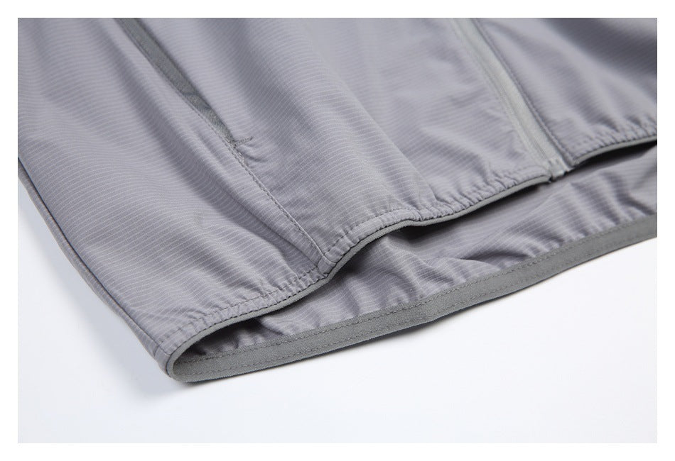 Close-up of the jacket's elasticated hem and stitched seam, showing the inner edge and fine stripes.