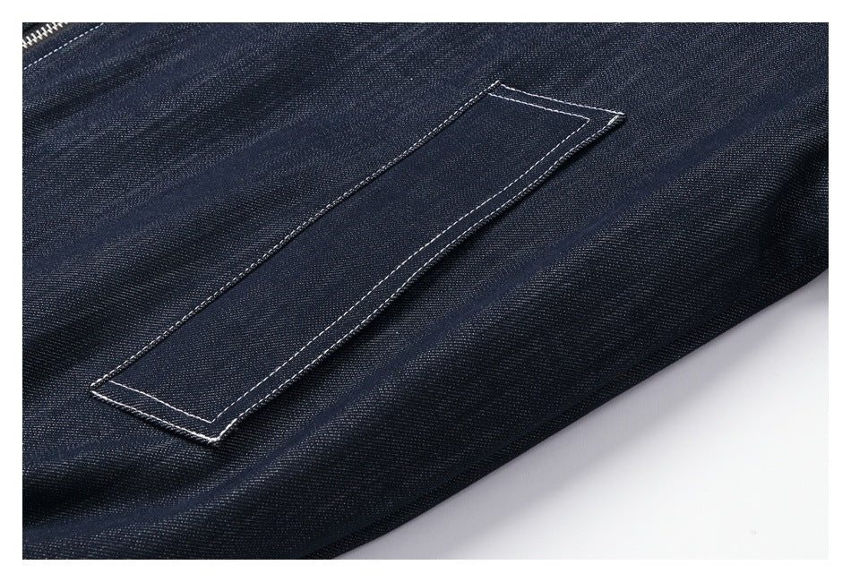 Close-up of a long rectangular stitched detail on dark indigo denim.