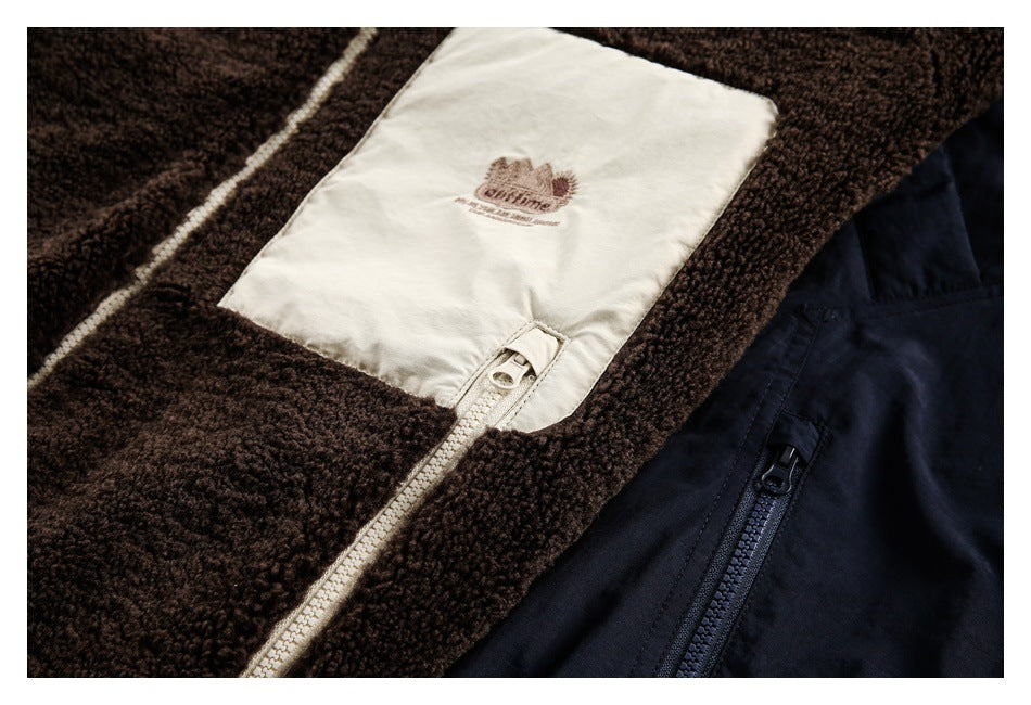 Close-up of brown fleece and cream jacket panels with an embroidered patch and zip pockets.