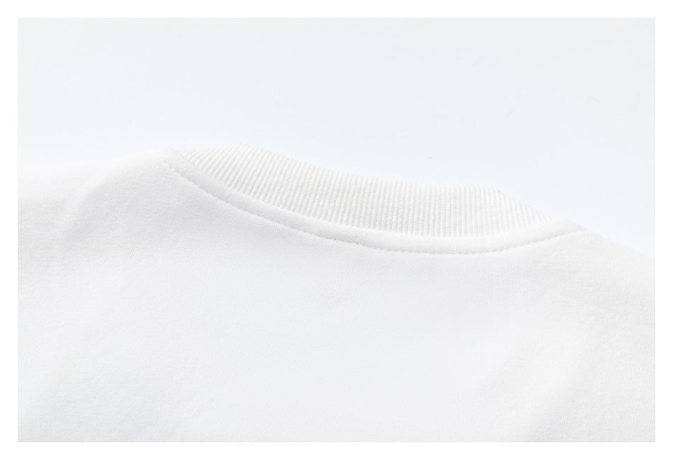 Close-up of the white sweatshirt’s ribbed crew neckline from the back.