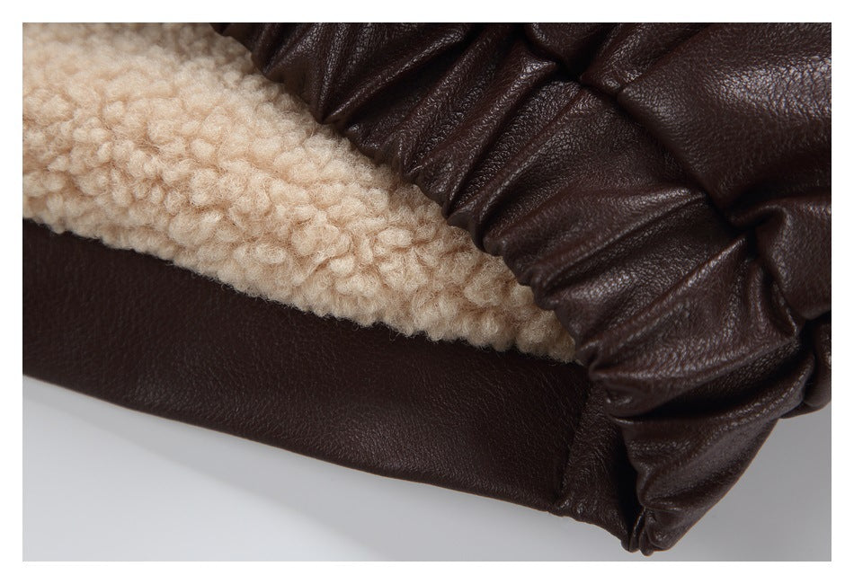 Close-up of cream textured lining and gathered dark brown jacket fabric at the edge.
