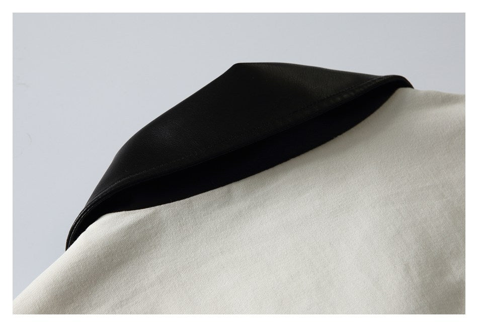 Close-up of an ivory garment with a contrasting black collar.