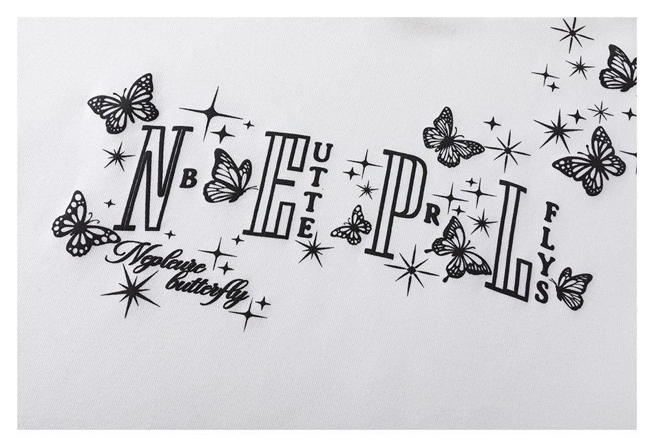 Close-up of the black butterfly, starburst, and lettering print on white sweatshirt fabric.