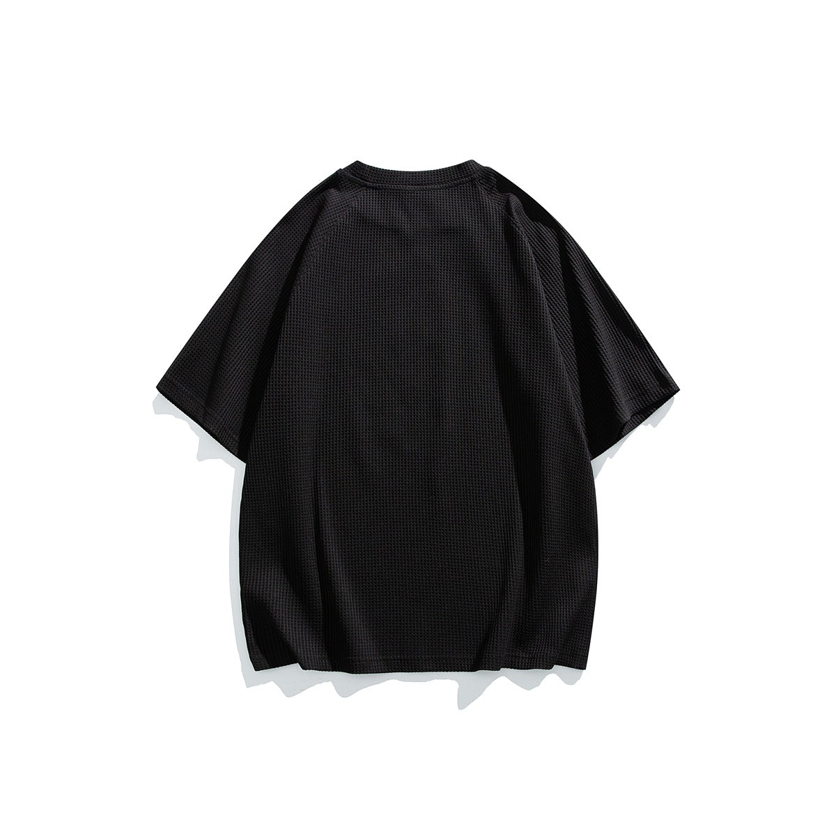 Back view of a black waffle-knit short-sleeve raglan T-shirt laid flat