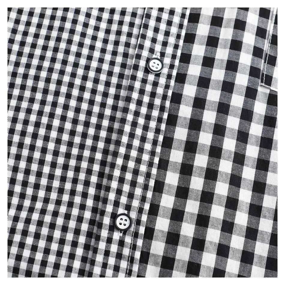 Close-up of the black-and-white gingham shirt front, showing two buttons and the placket.