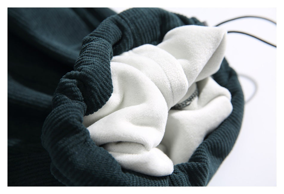 Close-up of dark teal pants showing the soft white interior lining.