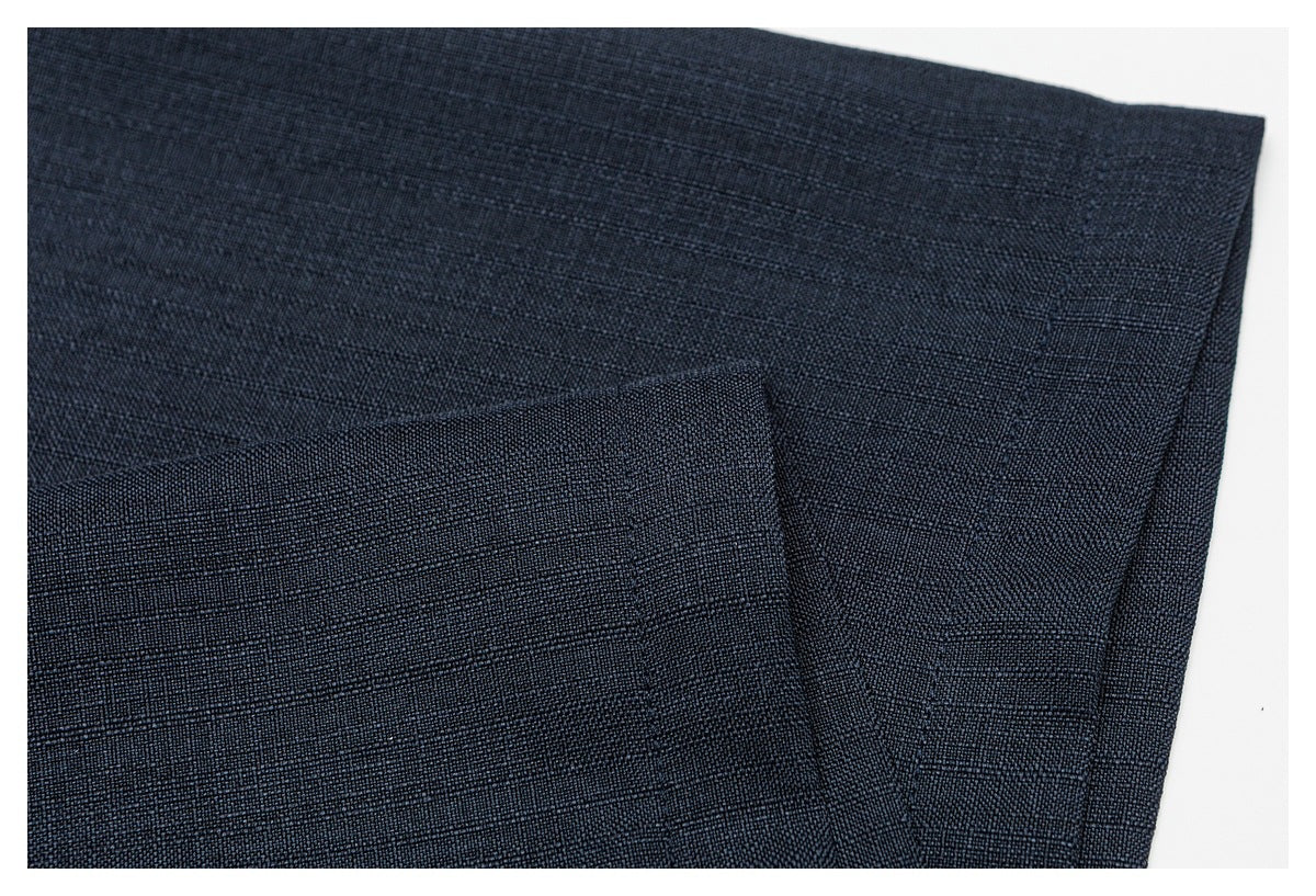 Close-up of overlapping dark navy fabric panels with a subtle woven texture.