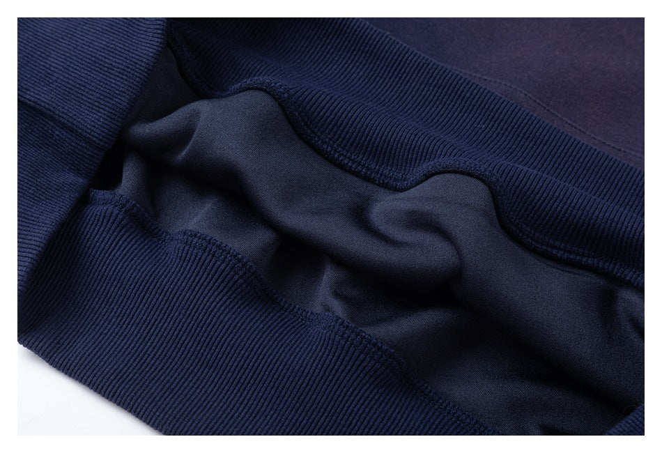 Close-up of navy garment showing ribbed trim and the inside seam construction.
