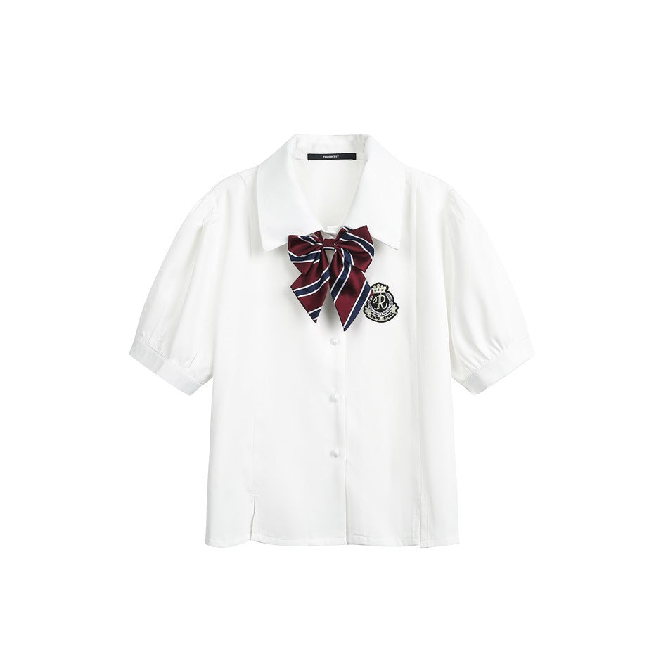 White short-sleeve button-front shirt with a pointed collar, burgundy-and-navy striped bow, and embroidered crest.