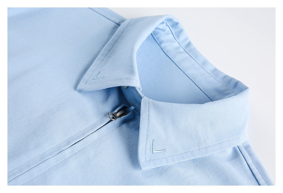 Close-up of the light blue jacket's pointed collar, stitching, and zipper beneath the collar.