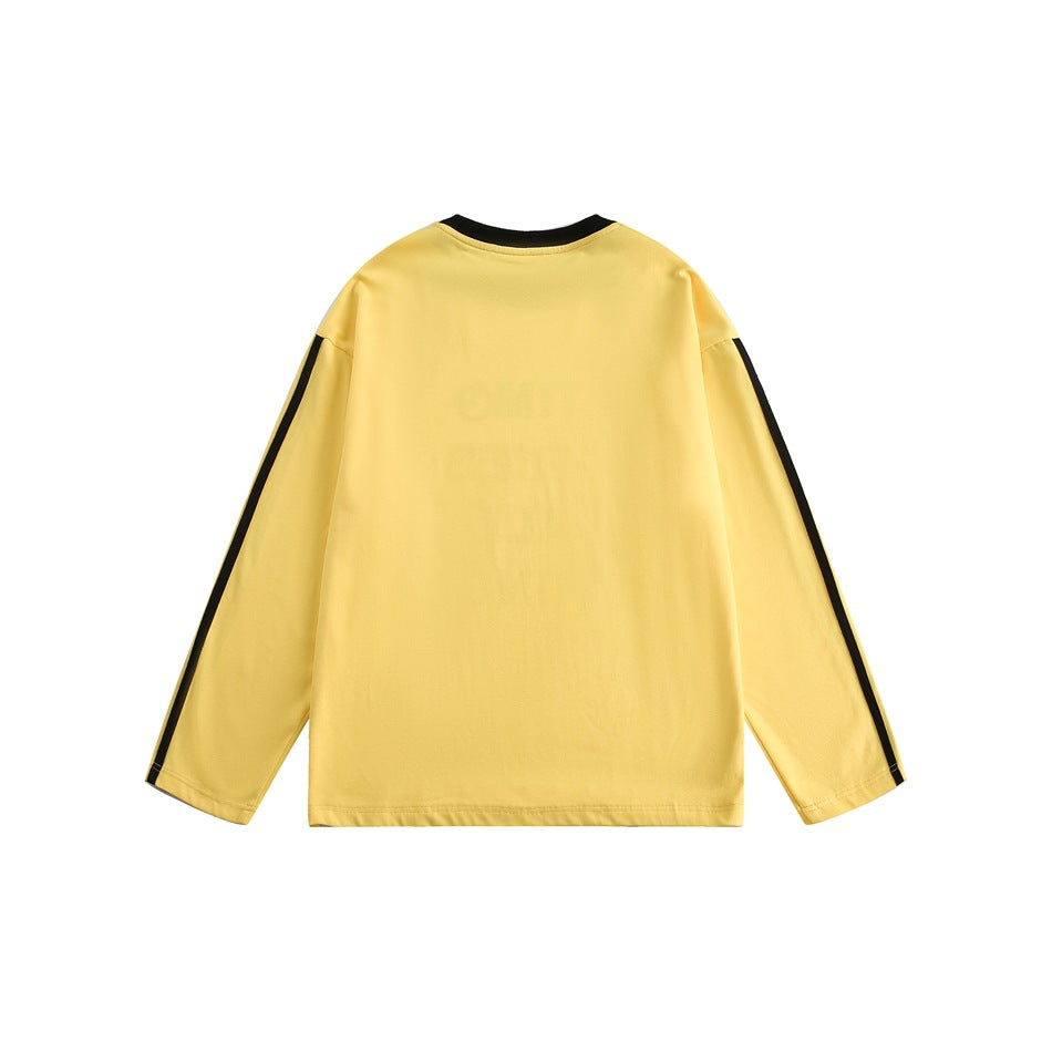 Back view of a yellow long-sleeve shirt with a black crew neck and black stripes along the sleeves.