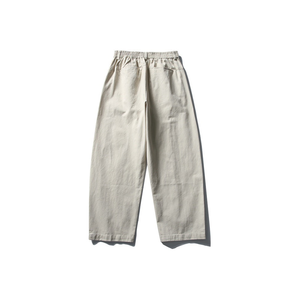 Back view of light beige wide-leg pants with an elastic waistband and two rear pockets.