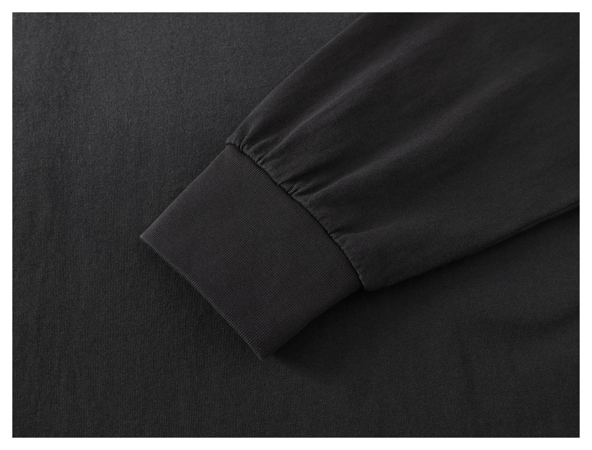 Close-up of a black sleeve with a wide ribbed cuff.