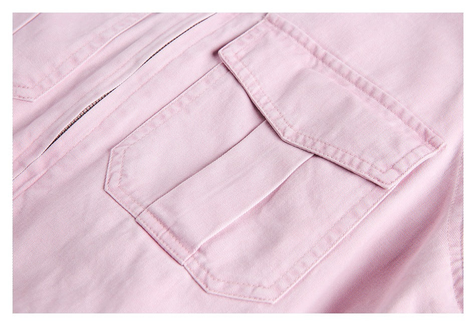 Close-up of a pale pink jacket chest pocket with a flap and visible stitching.