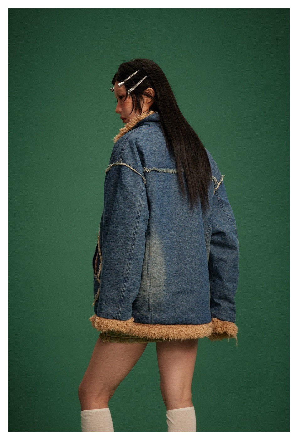 Model wearing the blue denim jacket, shown from behind with tan lining at the collar, cuffs, and hem.