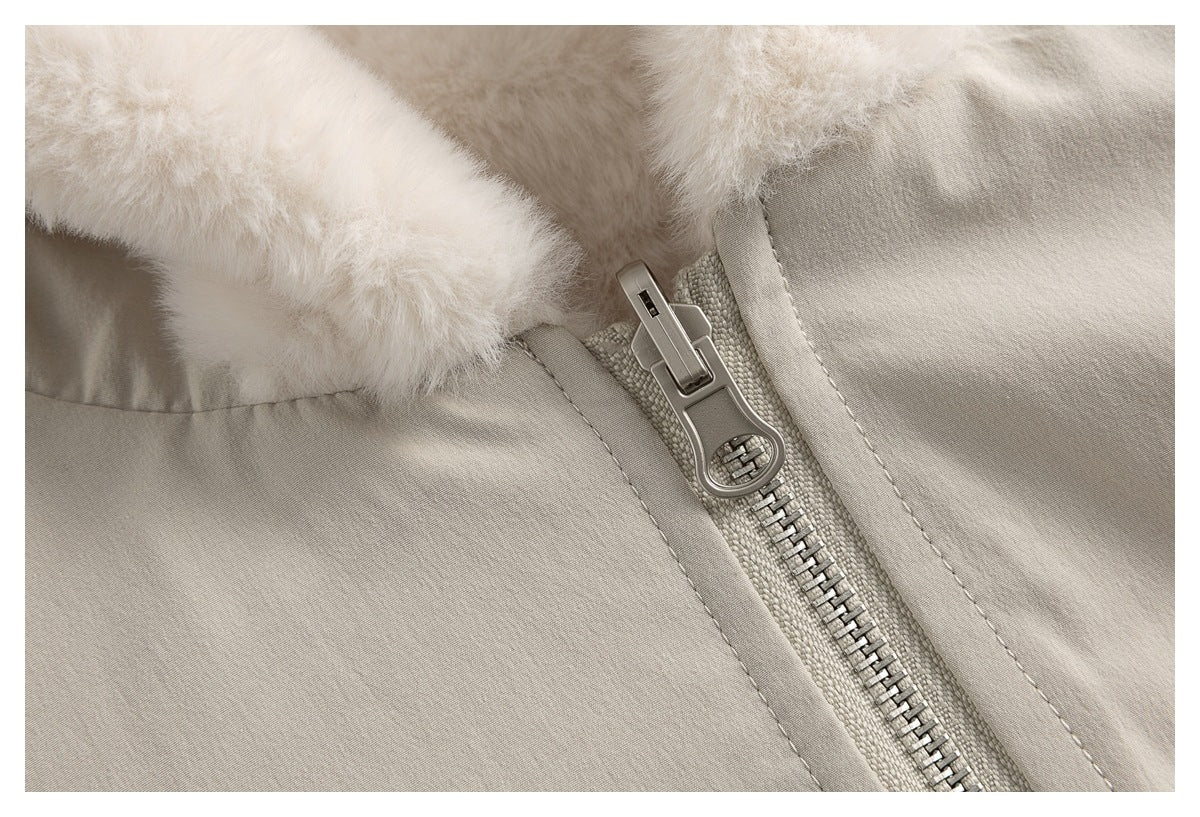 Close-up of a light jacket’s metal zipper, pull, stitching, and plush hood trim.