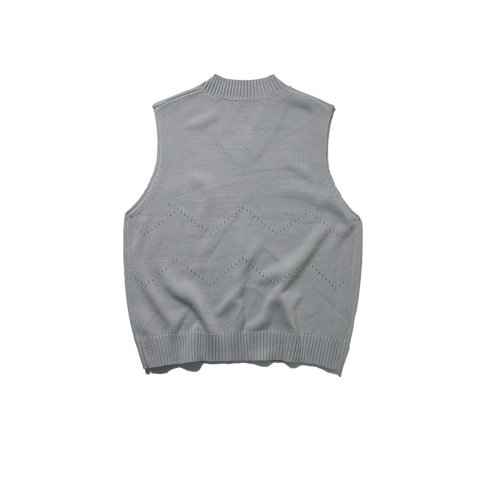 Back view of gray knit sweater vest with rounded ribbed neckline and zigzag eyelet pattern