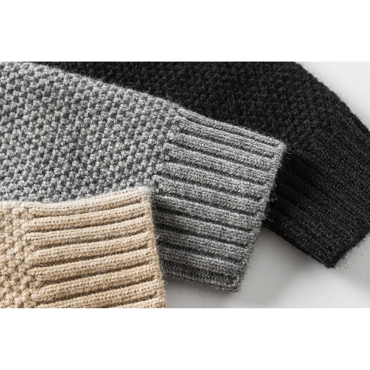 Close-up of cardigan cuffs in beige, gray, and black, showing ribbed knit edges.