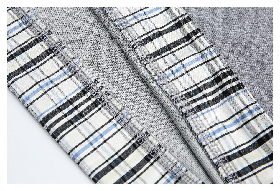 Interior close-up showing gray fabric, plaid facing, and overlocked seams.