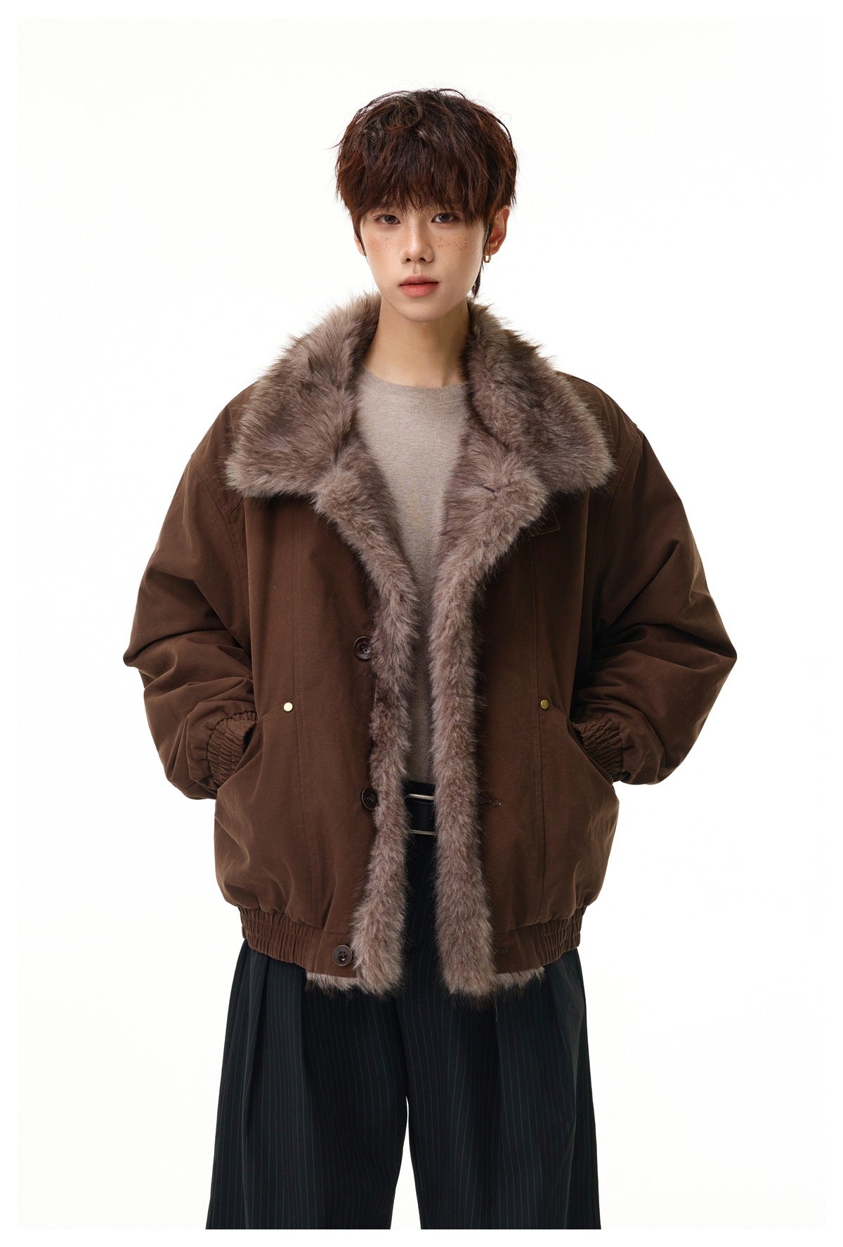 Model wearing a dark brown jacket with a wide gray-brown faux-fur collar and front trim.