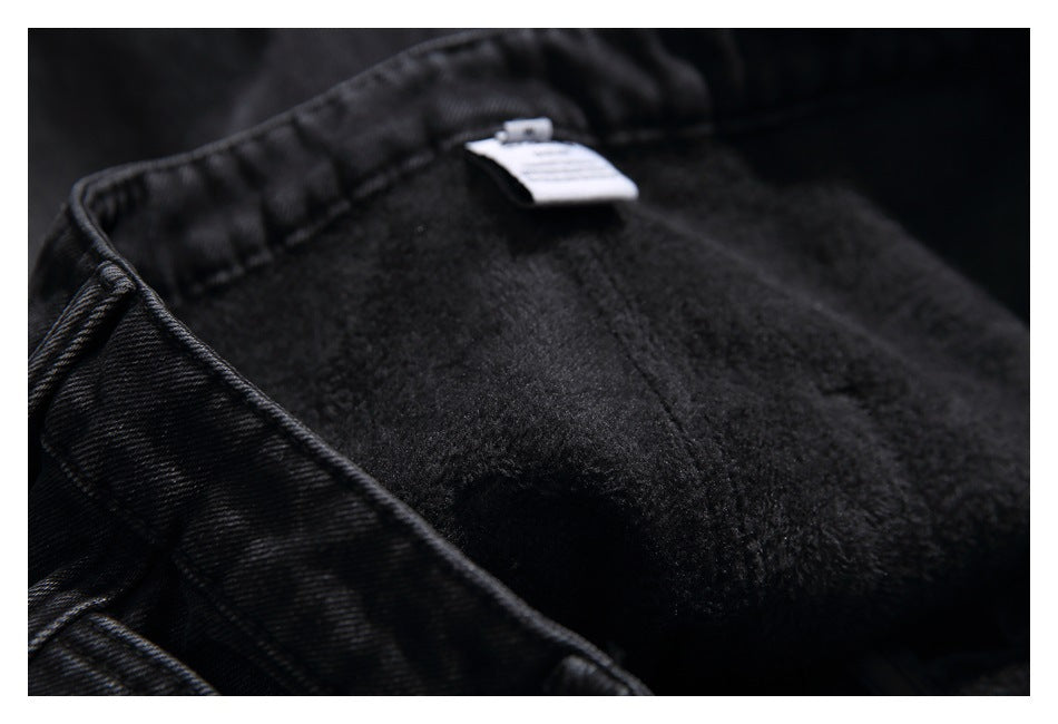 Close-up showing the soft, dark fleece lining inside black jeans and a small sewn-in label.